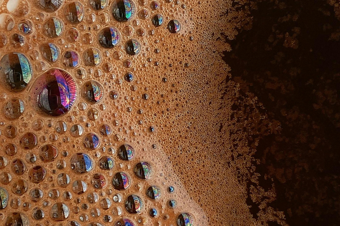 Close-up of rich espresso crema with coffee bubbles, showing texture and detail — representing improved extraction from Solis espresso machines using the IMS shower screen.