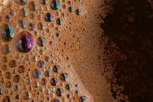 Close-up of rich espresso crema with coffee bubbles, showing texture and detail — representing improved extraction from Solis espresso machines using the IMS shower screen.